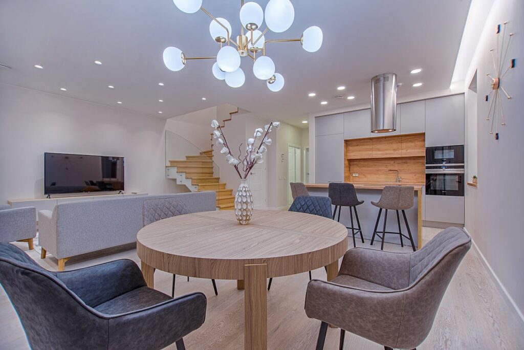 Round Brown Wooden Table With Chairs Inside Room